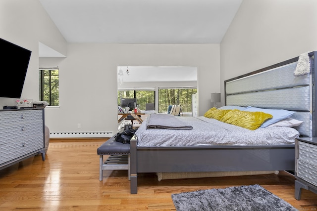 67 Woodside Cir Unit 67, Torrington, CT 06790 - bedroom with a baseboard radiator, multiple windows, wood finished floors, and high vaulted ceiling