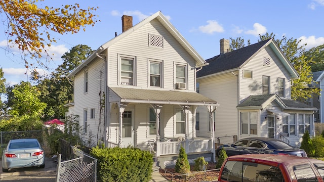 77 3rd St, New Haven, CT 06519 - view of front facade with covered porch, a chimney, and cooling unit