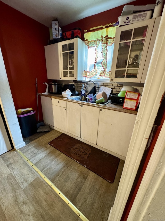 81 Easton Ave, Waterbury, CT 06704 - kitchen with wood finished floors, backsplash, and glass insert cabinets