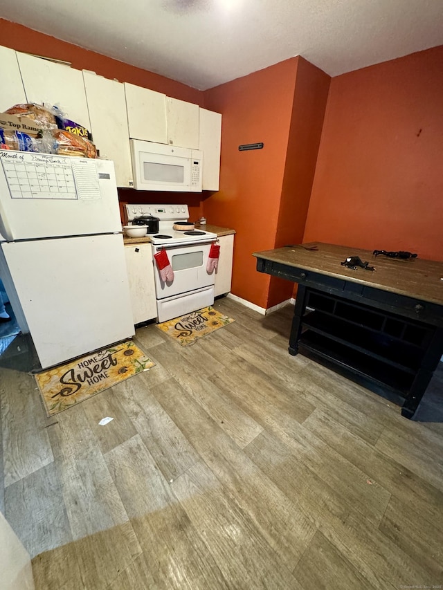 81 Easton Ave, Waterbury, CT 06704 - kitchen featuring white appliances, light wood-type flooring, and white cabinetry