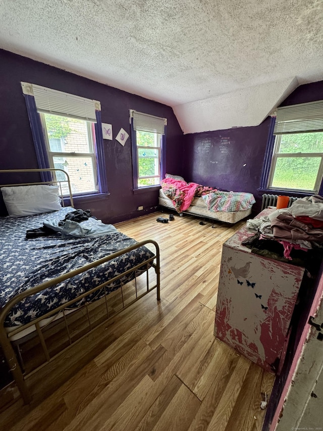 81 Easton Ave, Waterbury, CT 06704 - bedroom featuring a textured ceiling, wood finished floors, and vaulted ceiling