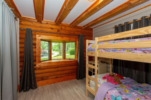 23 Center St, Thompson, CT 06277 - bedroom with wood finished floors, log walls, and beamed ceiling