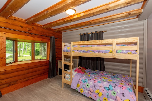23 Center St, Thompson, CT 06277 - bedroom with a baseboard heating unit, rustic walls, wood finished floors, and beam ceiling