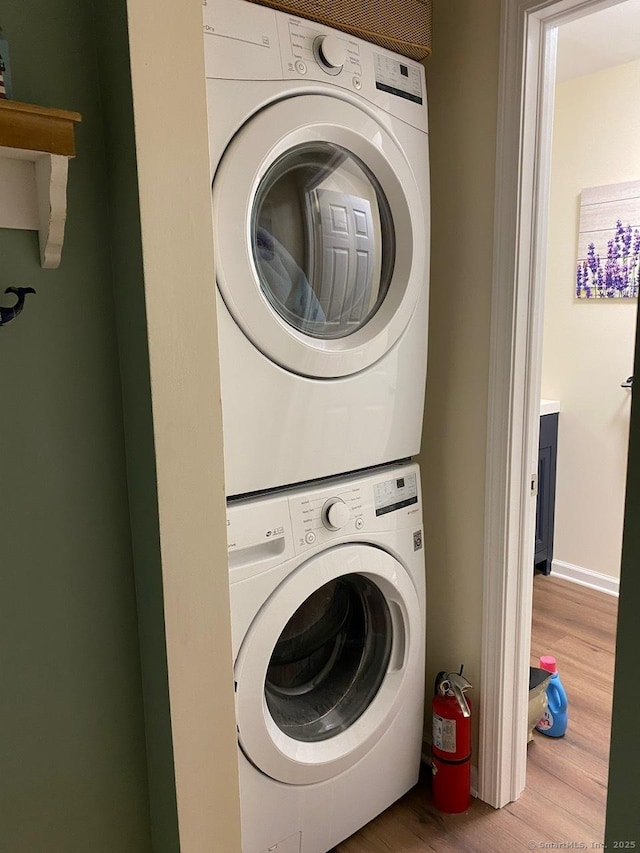 175 W Walk Unit 175, West Haven, CT 06516 - laundry area featuring stacked washer / dryer and wood finished floors
