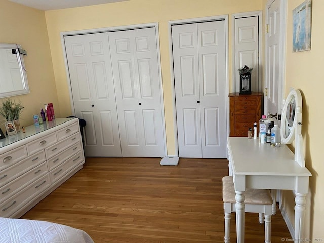 175 W Walk Unit 175, West Haven, CT 06516 - bedroom featuring wood finished floors and two closets
