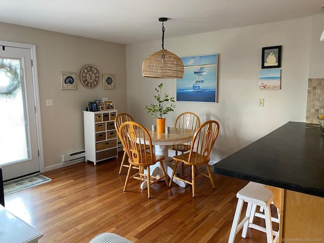 175 W Walk Unit 175, West Haven, CT 06516 - dining area featuring baseboard heating, wood finished floors, and healthy amount of natural light