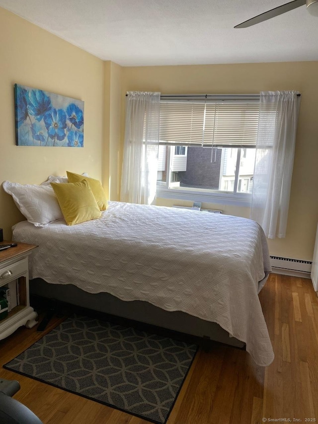 175 W Walk Unit 175, West Haven, CT 06516 - bedroom with baseboard heating, wood finished floors, and ceiling fan
