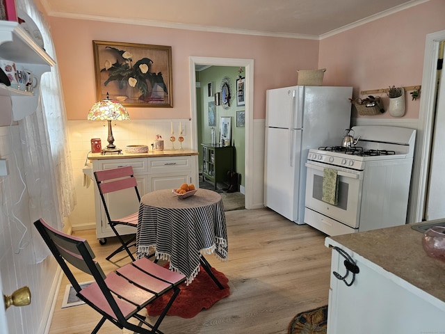 346 Pine St, Bristol, CT 06010 - kitchen featuring white appliances, light wood-style flooring, ornamental molding, and white cabinets