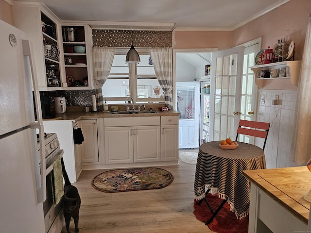 346 Pine St, Bristol, CT 06010 - kitchen with white appliances, open shelves, light wood-style flooring, crown molding, and wooden counters