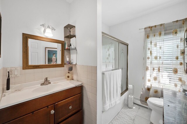 385 Blatchley Ave, New Haven, CT 06513 - bathroom with vanity, a baseboard heating unit, tile patterned floors, and tile walls