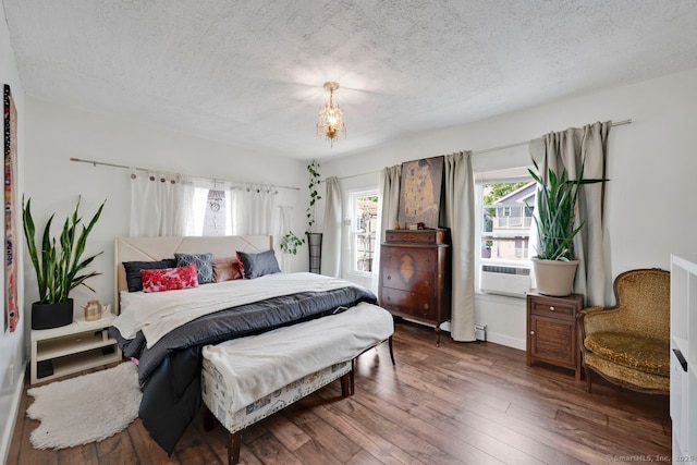 385 Blatchley Ave, New Haven, CT 06513 - bedroom with a textured ceiling, hardwood / wood-style flooring, cooling unit, and a chandelier