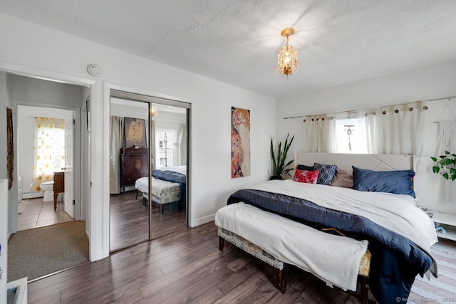 385 Blatchley Ave, New Haven, CT 06513 - bedroom with multiple windows, a closet, a chandelier, wood finished floors, and a textured ceiling