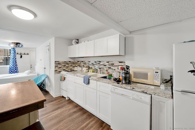 385 Blatchley Ave, New Haven, CT 06513 - kitchen featuring white appliances, light wood-type flooring, decorative backsplash, white cabinetry, and light stone countertops