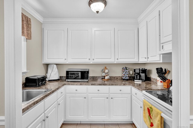 98 Morningside Dr W, Bristol, CT 06010 - kitchen with electric range, white cabinets, stainless steel microwave, crown molding, and light tile patterned floors
