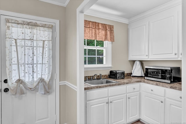 98 Morningside Dr W, Bristol, CT 06010 - kitchen with stainless steel microwave, white cabinetry, and crown molding