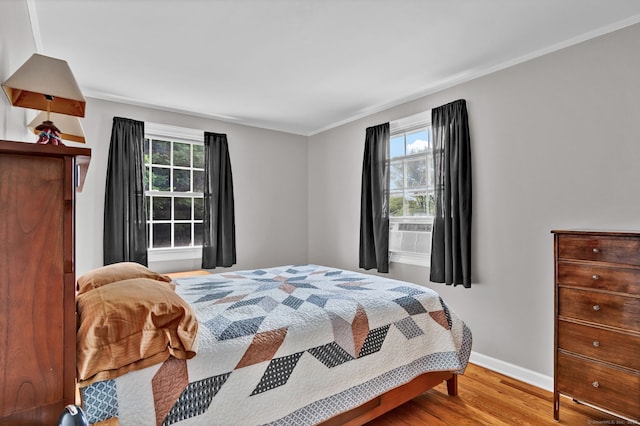 98 Morningside Dr W, Bristol, CT 06010 - bedroom with multiple windows, wood finished floors, cooling unit, and crown molding
