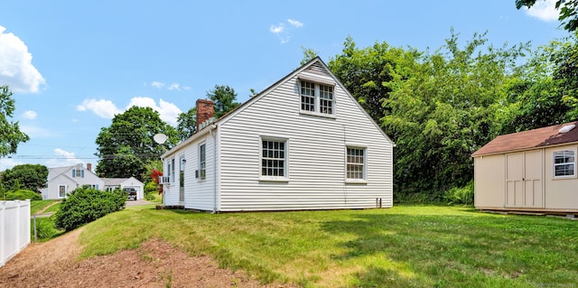 98 Morningside Dr W, Bristol, CT 06010 - back of property featuring a chimney, a yard, and a storage unit