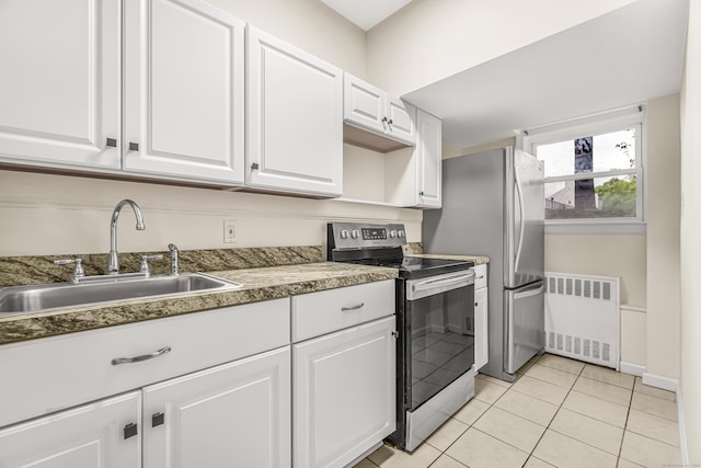 80 Cartright St Unit Gc, Bridgeport, CT 06604 - kitchen with stainless steel appliances, radiator heating unit, white cabinets, and light tile patterned floors