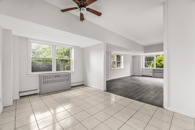 80 Cartright St Unit Gc, Bridgeport, CT 06604 - empty room featuring radiator heating unit, baseboard heating, plenty of natural light, and vaulted ceiling