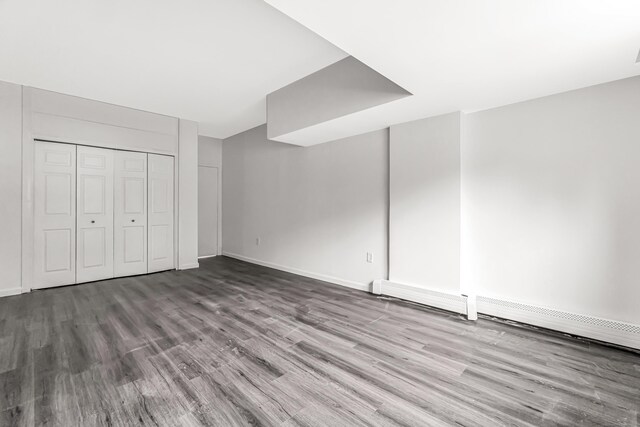 80 Cartright St Unit Gc, Bridgeport, CT 06604 - unfurnished bedroom with wood finished floors, a baseboard heating unit, and a closet