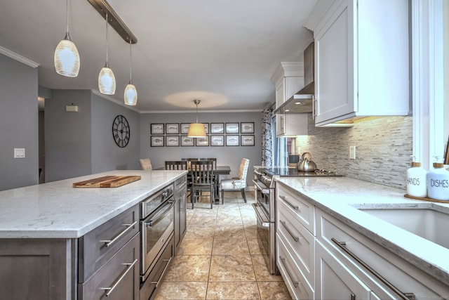 31 Meadowview Dr, Trumbull, CT 06611 - kitchen featuring stainless steel appliances, tasteful backsplash, white cabinets, light stone countertops, and a kitchen island