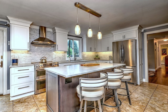 31 Meadowview Dr, Trumbull, CT 06611 - kitchen with stainless steel appliances, wall chimney range hood, light stone countertops, a kitchen island, and decorative backsplash