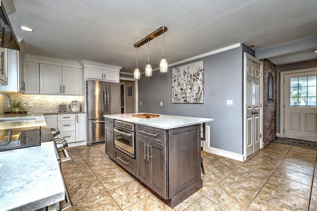 31 Meadowview Dr, Trumbull, CT 06611 - kitchen with stainless steel appliances, white cabinets, backsplash, a kitchen island, and hanging light fixtures