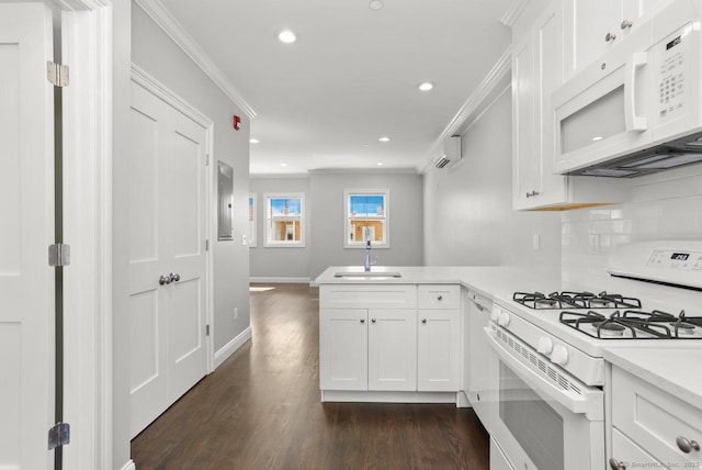 4 Armonk St, Greenwich, CT 06830 - kitchen with white appliances, a wall mounted AC, light countertops, a peninsula, and crown molding