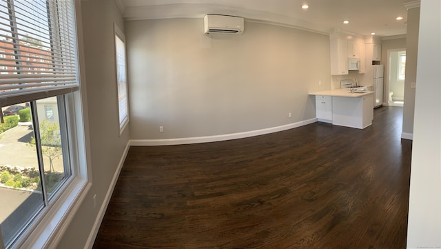 4 Armonk St, Greenwich, CT 06830 - unfurnished living room featuring a wall unit AC, dark wood-type flooring, healthy amount of natural light, crown molding, and recessed lighting
