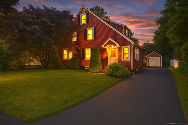 51 Carmel St, Hamden, CT 06518 - view of front of property with asphalt driveway, an outbuilding, a garage, and a yard