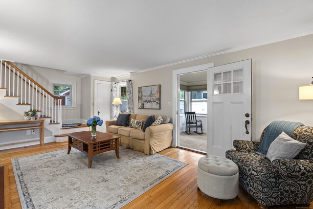51 Carmel St, Hamden, CT 06518 - living room featuring ornamental molding, stairs, healthy amount of natural light, and wood finished floors