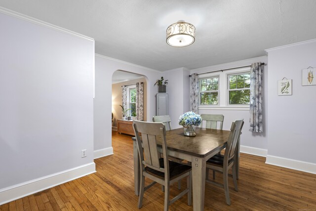 51 Carmel St, Hamden, CT 06518 - dining area featuring arched walkways, wood finished floors, and ornamental molding