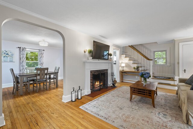 51 Carmel St, Hamden, CT 06518 - living area featuring arched walkways, wood finished floors, ornamental molding, and healthy amount of natural light