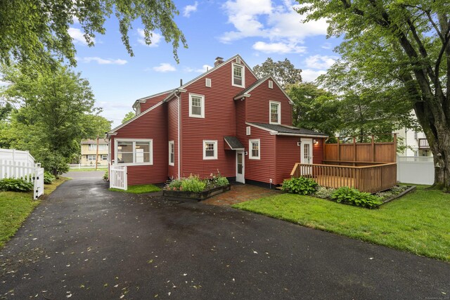 51 Carmel St, Hamden, CT 06518 - view of front facade with a chimney, a wooden deck, and driveway