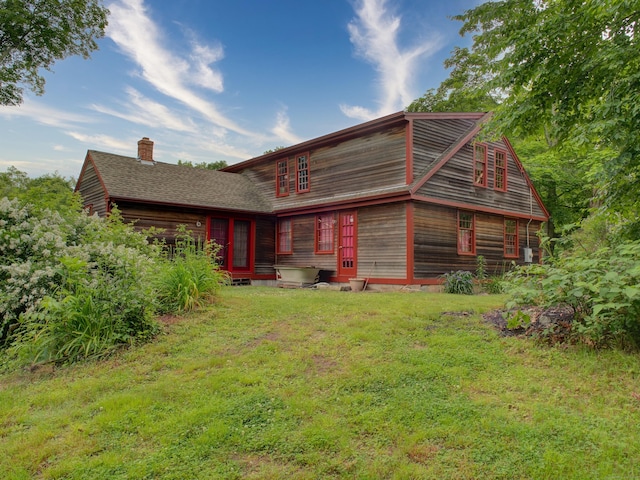 291 Cossaduck Hill Rd, North Stonington, CT 06359 - rear view of house featuring a chimney, a lawn, entry steps, a garage, and a shingled roof