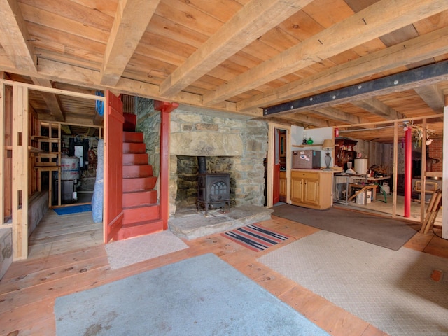 291 Cossaduck Hill Rd, North Stonington, CT 06359 - below grade area featuring wooden ceiling, a wood stove, hardwood / wood-style flooring, and stairs