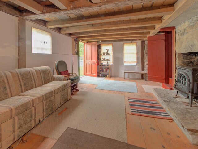 291 Cossaduck Hill Rd, North Stonington, CT 06359 - living area featuring a wood stove, plenty of natural light, hardwood / wood-style flooring, and a wooden ceiling with exposed beams