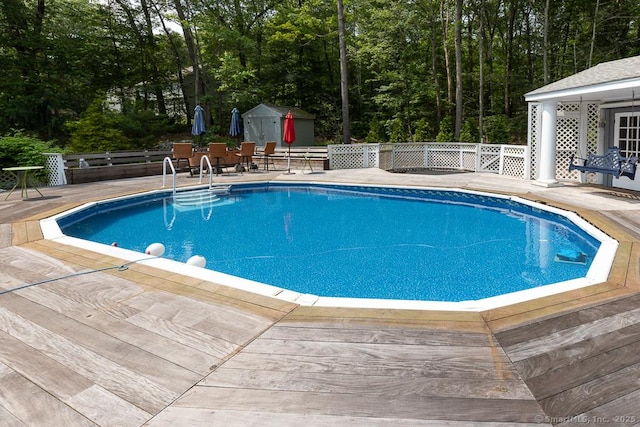 328 Old Marlborough Tpke, Portland, CT 06480 - swimming pool with a wooden deck, a shed, and view of wooded area