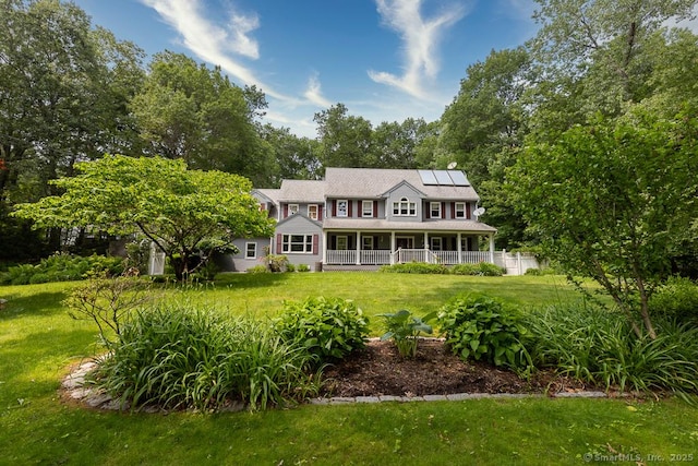 328 Old Marlborough Tpke, Portland, CT 06480 - rear view of house with roof mounted solar panels, a lawn, and a porch