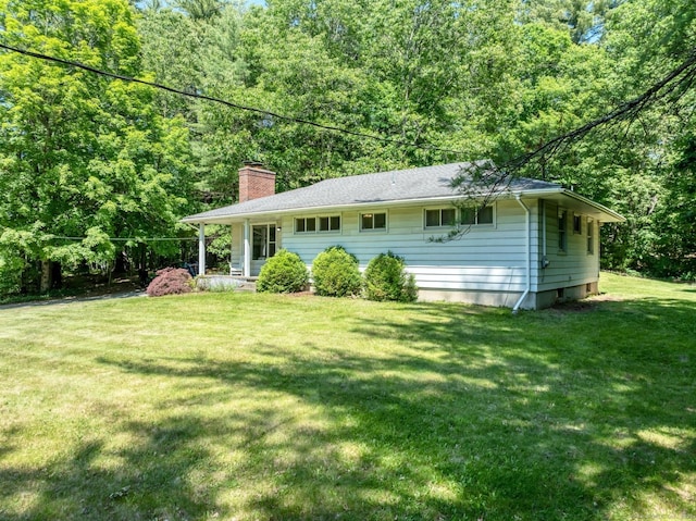 123 Geer Rd, Griswold, CT 06351 - view of front of home with a chimney, a front lawn, and a forest view