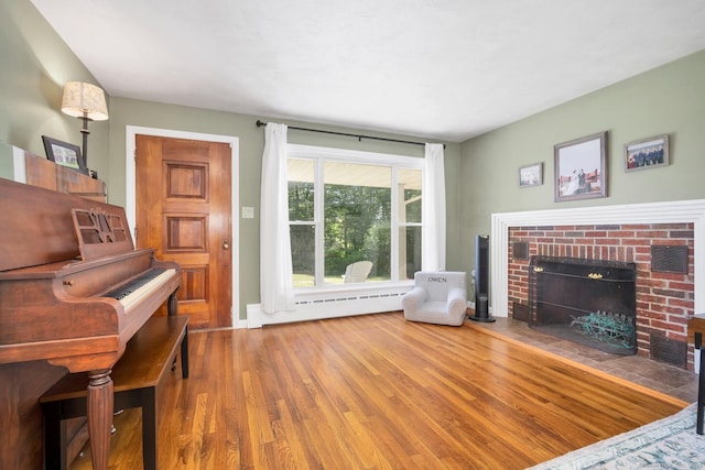 123 Geer Rd, Griswold, CT 06351 - living room with a fireplace, a baseboard radiator, and wood finished floors