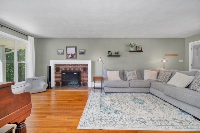 123 Geer Rd, Griswold, CT 06351 - living room with light wood finished floors and a brick fireplace