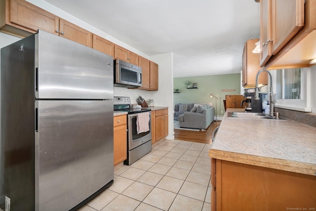 123 Geer Rd, Griswold, CT 06351 - kitchen featuring stainless steel appliances, light tile patterned floors, light countertops, and open floor plan
