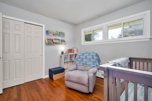 123 Geer Rd, Griswold, CT 06351 - bedroom featuring wood finished floors, a closet, and a baseboard radiator
