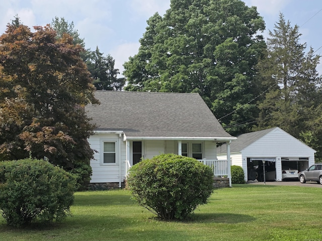 55 Defashion St, Southington, CT 06479 - view of front of house featuring an outdoor structure, covered porch, a garage, a front lawn, and a shingled roof