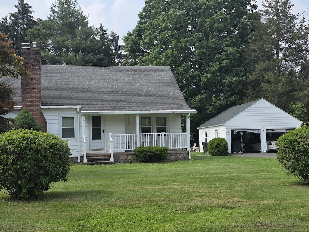 55 Defashion St, Southington, CT 06479 - view of front of house with a porch, a garage, an outdoor structure, a chimney, and a front yard