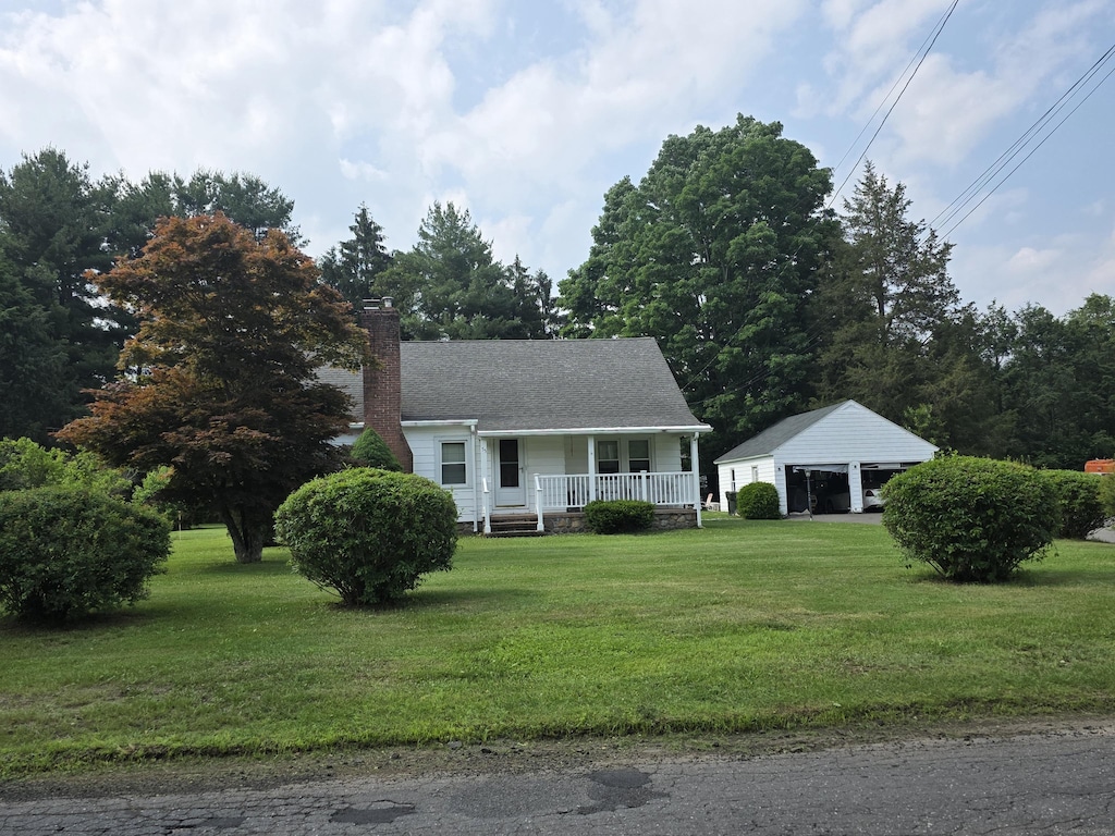 55 Defashion St, Southington, CT 06479 - view of front of house with covered porch, a front lawn, and a chimney