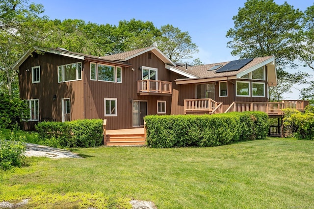 162 Shortwoods Rd, New Fairfield, CT 06812 - back of house featuring roof mounted solar panels, a balcony, a yard, and a shingled roof