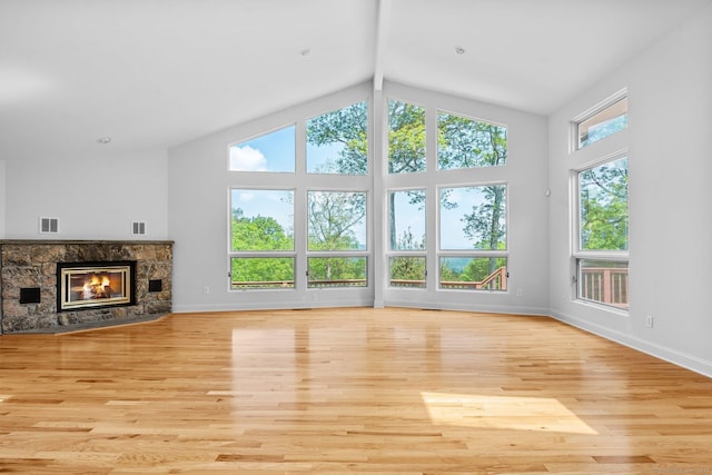 162 Shortwoods Rd, New Fairfield, CT 06812 - unfurnished living room with wood finished floors, a stone fireplace, high vaulted ceiling, and beam ceiling