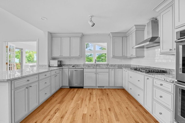 162 Shortwoods Rd, New Fairfield, CT 06812 - kitchen featuring stainless steel appliances, wall chimney range hood, healthy amount of natural light, and decorative backsplash
